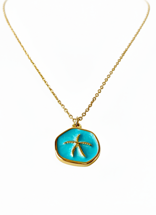 Necklace with a turquoise pendant featuring a starfish design on a white background