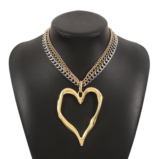 Gold heart-shaped necklace on a black mannequin bust