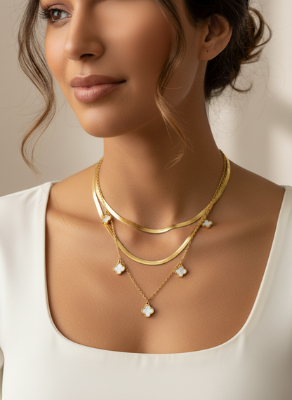 Woman wearing a gold necklace with clover charms