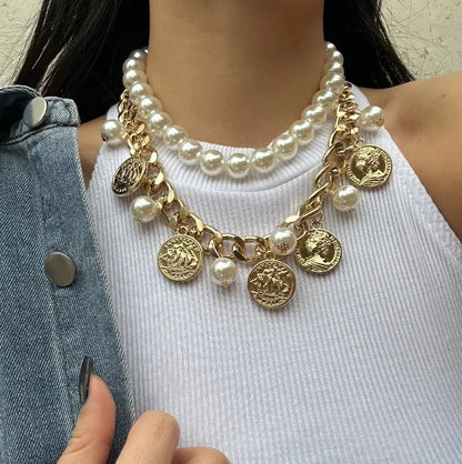 Necklace with pearls and gold coins worn by a person