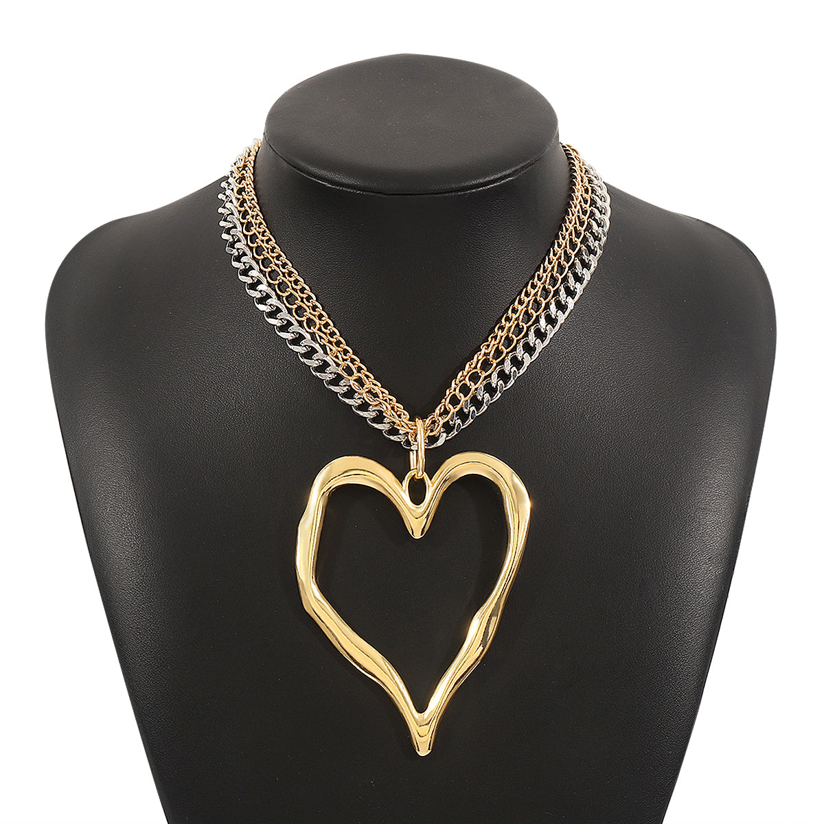Gold heart-shaped necklace on a black mannequin bust