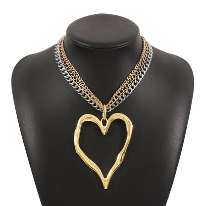 Gold heart-shaped necklace on a black mannequin bust