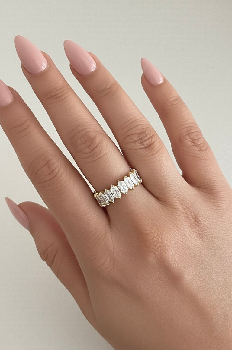 Close-up of a hand wearing a diamond ring with a white background