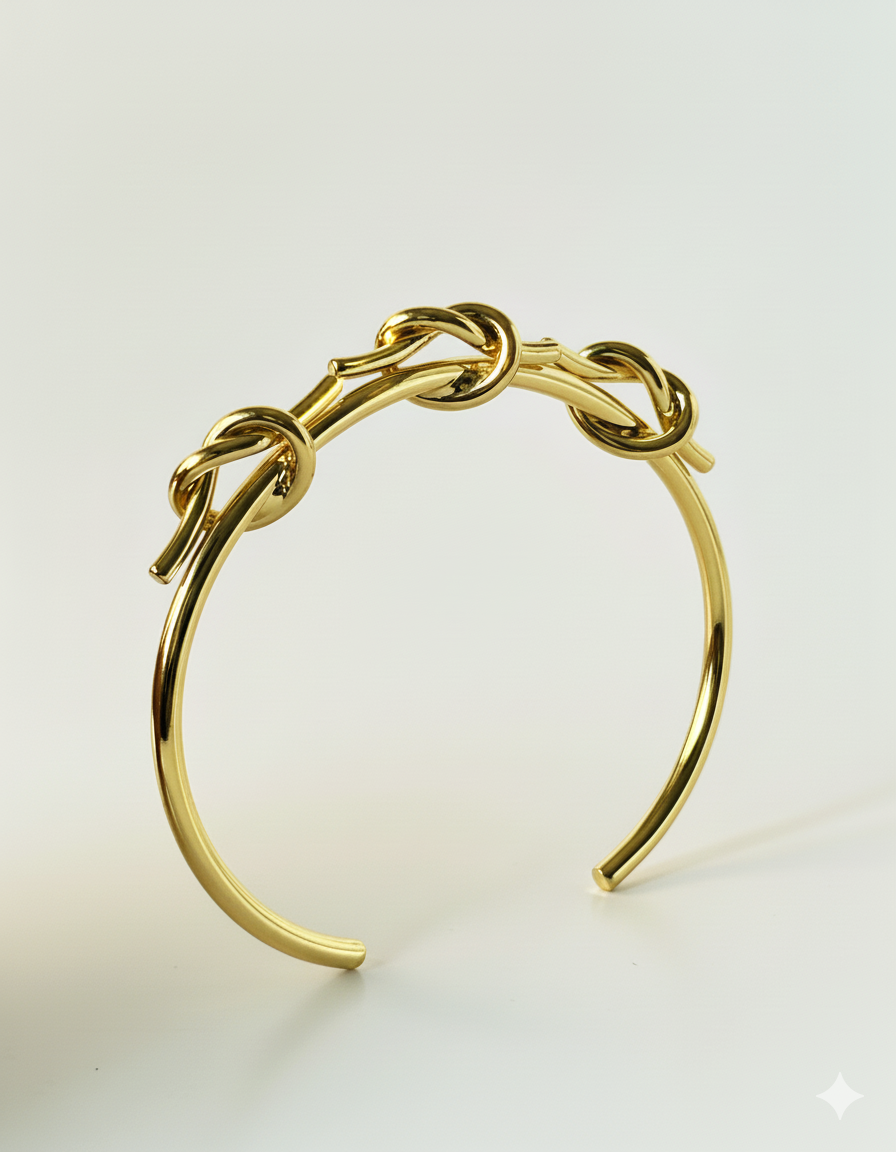 Gold bracelet on a light beige background