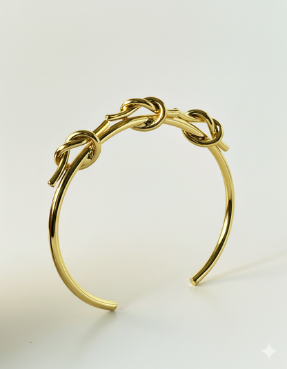 Gold bracelet on a light beige background