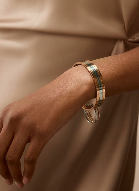 Gold and silver stack bangles worn on a hand