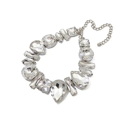 Silver necklace with clear gemstones on a white background