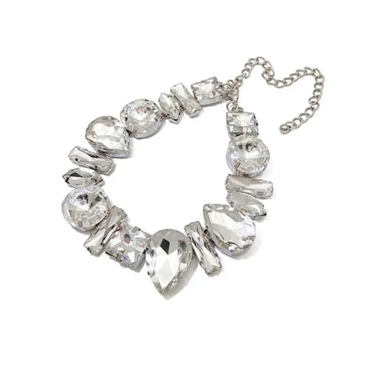 Silver necklace with clear gemstones on a white background