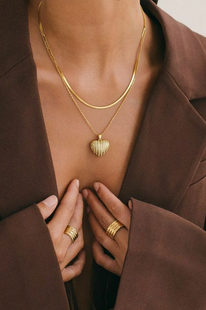 Woman wearing heart pendant 2-layered necklace