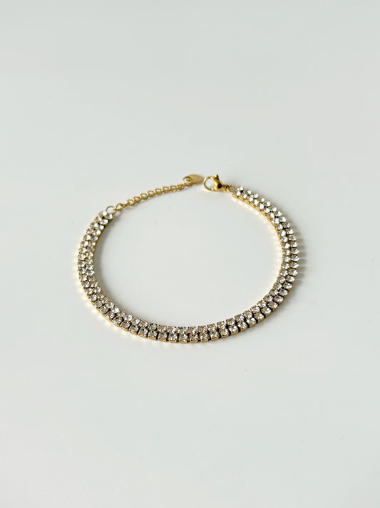 Gold tennis bracelet with clear stones