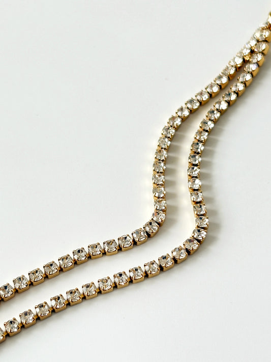 Gold tennis bracelet with clear gemstones 